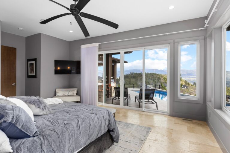 Bedroom with a walkout to a covered patio, Kelowna home interior