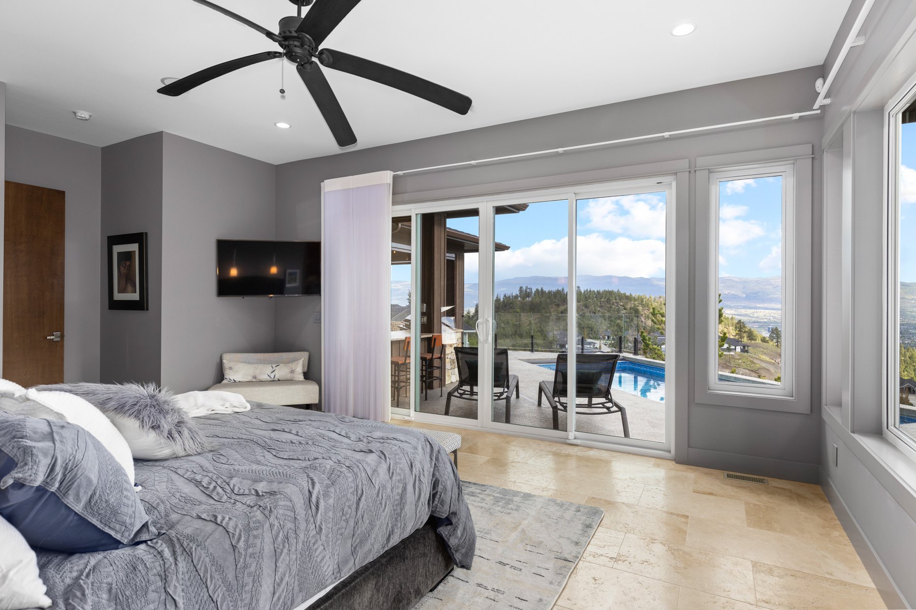 Bedroom with a walkout to a covered patio, Kelowna home interior