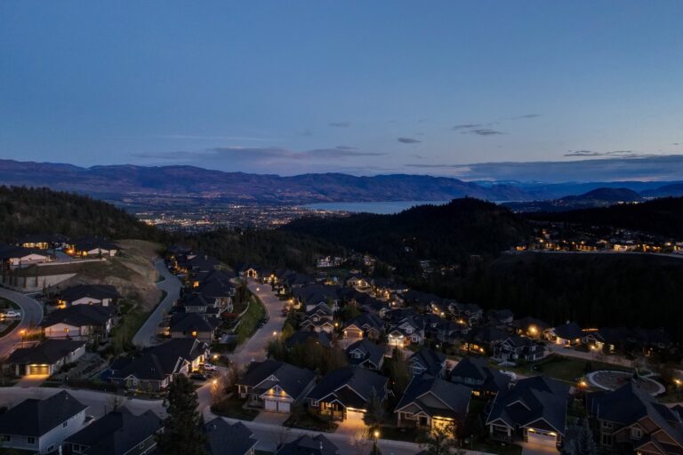 Aerial view over the Okanagan valley at dusk with town lights below, Kelowna